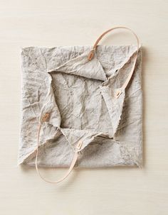 a piece of paper with some string attached to it