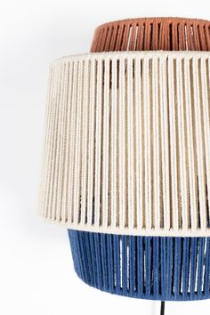 a blue and brown lamp shade on a white background