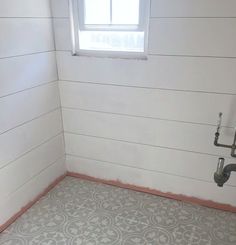 a bathroom with a toilet and window in it