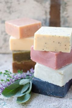 soap bars stacked on top of each other with lavender sprigs in the background