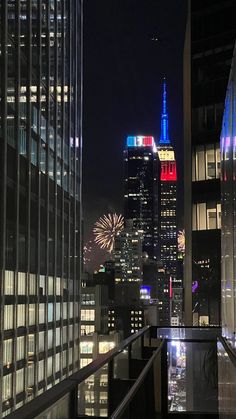 the city skyline is lit up in red, white and blue for fourth of july