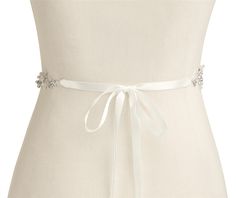 Floral Pearl and Crystal Wedding Dress Belt Our elegant hand-crafted silver bridal belt glistens with matte silver flowers, pave leaves and dainty sprays of sparkling crystals and ivory pearls. This beautiful wedding sash with its on-trend floral vine motif will be the perfect complement to your bridal gown. Size: The decorative appliqué measures 19" long and 1" wide. The ivory satin ribbon is 3/8" wide. Total belt length is 107" (can be trimmed for a perfect fit). Color: Silver//Ivory. Style: 4 Elegant White Bride Sashes, White Crystal Embellished Bridal Sash, Elegant Silver Bridal Belt For Bridesmaids, Elegant Silver Bridal Belt For Wedding, Silver Bridesmaid Sashes Bridal Accessories, White Pearl Embellished Sashes For Wedding, White Rhinestones Bridesmaid Bridal Accessories, Elegant White Sashes For Bridal Shower, Dress Sash Belt