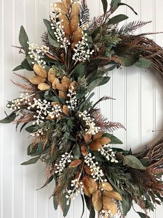 a wreath with white flowers and green leaves