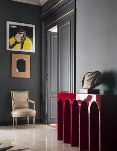 a room with gray walls and red furniture