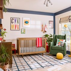 a baby's room with a green chair and a yellow ball in the middle