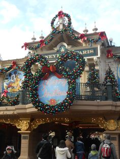 the entrance to mickey mouse's christmas wonderland at disneyland world is decorated with lights and decorations