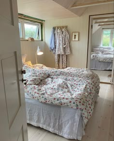 an open door leading to a bedroom with a bed and dresser in the corner,