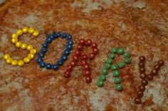 a close up of a pizza with the word doh spelled out in beads on it