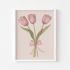 pink tulips with a bow on a pale background framed in a white frame