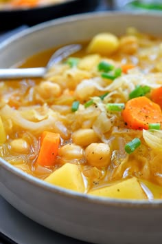 a white bowl filled with soup and vegetables