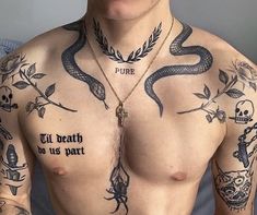 a shirtless man with tattoos on his chest