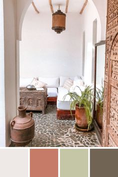 a living room filled with lots of furniture and decorating items in shades of pink, green