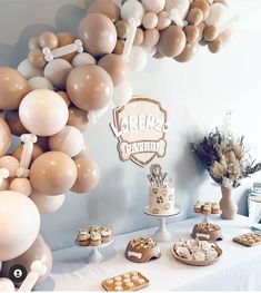 a table with desserts and balloons on it