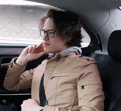 a woman sitting in the back seat of a car