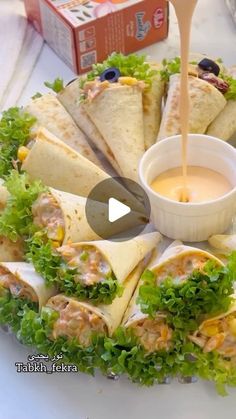 a plate filled with pita sandwiches and dipping sauce