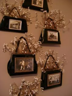 several framed pictures hang on the wall with baby's breath flowers in front of them