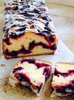 a loaf of blueberry cheesecake on a cutting board with four slices cut out