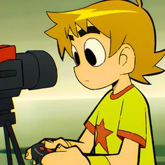 a young boy sitting in front of a camera