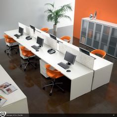 an office cubicle with orange and white desks