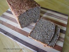 a loaf of bread sitting on top of a wooden cutting board