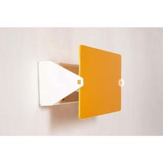 an orange and white wall mounted shelf with a paper holder on the top of it