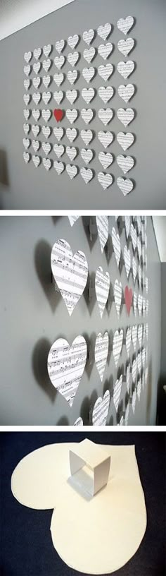 some paper hearts are hanging on the wall and one has been cut out to make it look