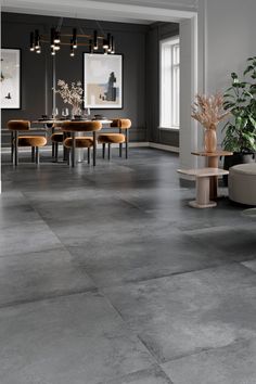 a dining room with gray walls and flooring