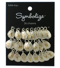 six charms with letters and numbers on them