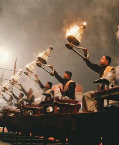 a group of men holding torches in their hands