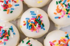 white cake balls with colorful sprinkles on them