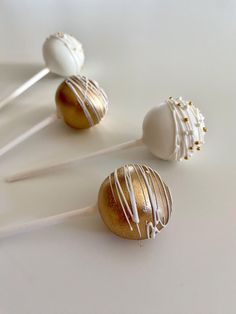 three chocolate covered lollipops sitting on top of each other with white icing