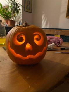 a carved pumpkin sitting on top of a wooden table