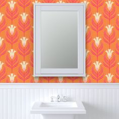 a bathroom sink sitting under a mirror next to a wall