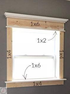 the measurements for an unfinished window frame are shown in front of a gray wall with white trim