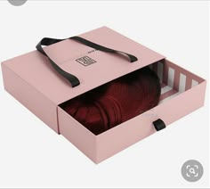 an open pink box with red hair inside