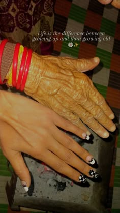 two hands with different colored bracelets on them