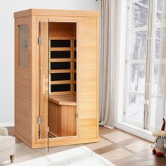 a wooden sauna in a living room next to a window