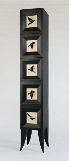 a black and white cabinet with four drawers