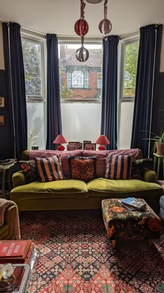 a living room filled with furniture and windows