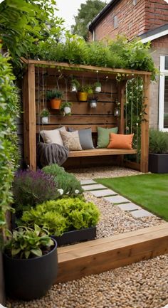 a wooden bench sitting in the middle of a garden next to a lush green lawn