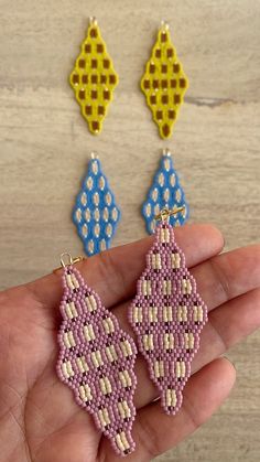 the beaded earrings have been made to look like they are being held in someone's hand