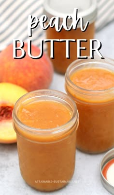 two jars filled with peach butter sitting on top of a table next to sliced peaches