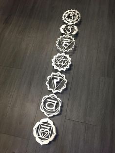 the seven chakras are arranged in a row on the floor, with one being drawn