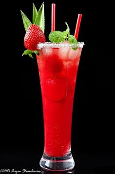 a red drink with strawberries and mint garnish