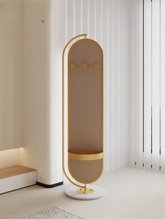 a white room with a round mirror on the wall and a gold stand next to it