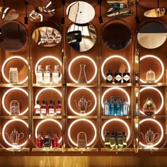 the shelves are filled with various bottles and circular lights, along with mirrors on them