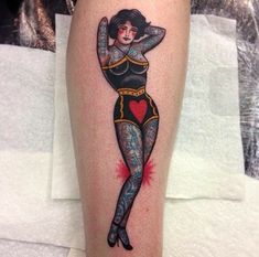 a woman's leg with a tattoo on it and a red heart in the center