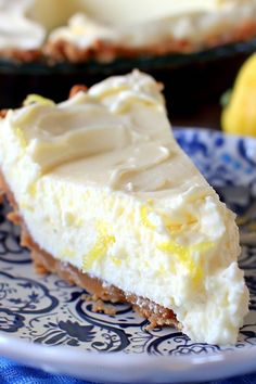 a slice of lemon pie on a blue and white plate