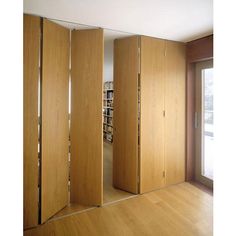 an empty room with wooden walls and sliding doors