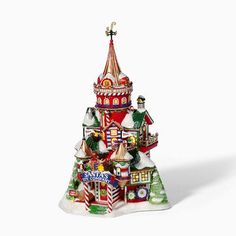 a christmas tree that is in the shape of a house with santa's helpers on it